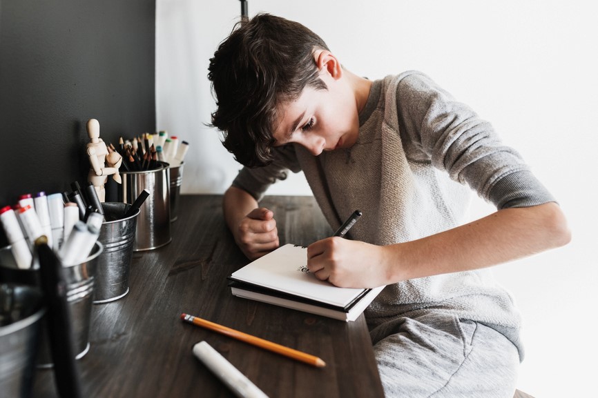 a boy doing homework on a desk